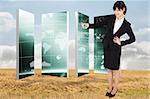 Smiling businesswoman pointing against bright brown landscape