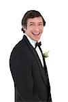 Portrait of cheerful groom in tuxedo over white background