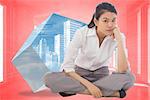 Grumpy businesswoman sitting cross legged against bright red room with windows