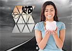 Attractive woman posing with a piggy bank against street under stormy sky