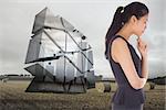 Thinking businesswoman against landscape with bales of straw