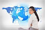 Businesswoman sitting cross legged frowning against blue world map on white background