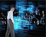 Happy businessman standing with hands in pockets against blue blurred texts
