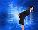 Serious businesswoman bending against abstract blue squares