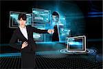 Businesswoman pointing against keyhole on technological background