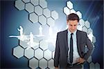Cheerful businessman standing with hand on hip against technological background with hexagons