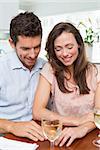 Loving young couple with wine glass at home