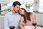 Loving young couple with wine glasses at home