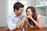 Close-up of a loving young couple sharing a drink at home