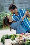 A couple embracing and dancing in a garden.