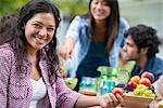 A summer party outdoors. Four friends at a table.