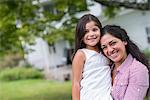 A mother and daughter in a country garden.