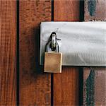 Close up of a wooden doorway, with a padlock.