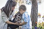 A child and adult looking at a bug box.