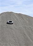 Gravel piles are used for road maintenance and construction purposes.