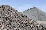 Gravel piles are used for road maintenance and construction purposes.