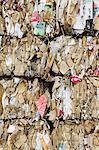 Recycling facility with bundles of cardboard sorted and tied up for recycling.