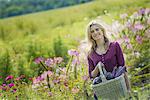 A woman in a garden full of flowers on an organic flower farm.