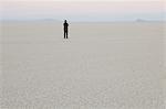 Man standing in vast, desert landscape