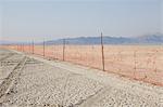 Fence barricade extending across the flat landscape, Black Rock Desert, Nevada, USA