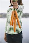 Nine year old girl holding organic carrots