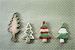 Organic homemade Christmas cookies shaped like Christmas trees, iced with green, red and white icing.