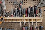 A reclaimed lumber workshop. A tool board, with slots for screwdrivers and handheld woodworking tools.