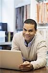 Man working in design shop with laptop