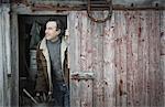 An organic farm in upstate New York, in winter. A man at an open barn door.