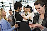 New York City park. People, men and women on a city bus. Public transport. Keeping in touch. A young woman checking or using her cell phone.