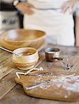 A domestic kitchen. A cook preparing a meal. A large bowl with oill and flour. Creating pastry.