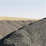 Gravel piles used for road maintenance and construction, a row of heaps near Pullman, Washington, USA.