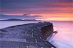 Sunrise in winter over the Jurassic Coast, UNESCO World Heritage Site, from The Cobb, Lyme Regis, Dorset, England, United Kingdom, Europe