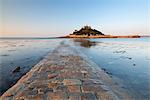 The stone causeway leading to St. Michaels Mount in early morning sunshine, Marazion, Cornwall, England, United Kingdom, Europe
