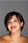 Head and Shoulders Portrait of Mid-Adult Woman with Grey Background