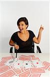 Mid-Adult Woman doing Magic Trick with Deck of Cards