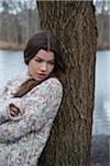 Portrait of Young Woman by Tree Trunk, Mannheim, Baden-Wurttemberg, Germany