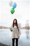 Portrait of Young Woman Outdoors with Balloons, Mannheim, Baden-Wurttemberg, Germany
