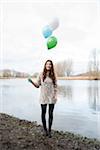 Portrait of Young Woman Outdoors with Balloons, Mannheim, Baden-Wurttemberg, Germany