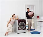 Housework, young woman and man doing laundry