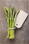 bunch of green asparagus tied with twine and tag, rustic style for market
