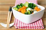 Bowls of variety vegetables with Chopstick on table