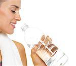 Closeup on fitness young woman drinking water