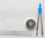 Still life photo of engineering graph paper with pencil, compass and metal ruler blank to add your own design