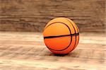 Toy basketball on wood background