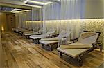 Relaxation area insode a luxury health spa with beds and towels