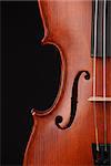 Close up of a violin on black background