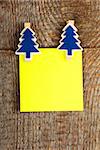 Clothes-peg in shape of Christmas tree on old wooden background