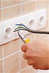 Electrician hands with wires and pliers - closeup