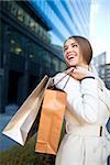 Beautiful girl with shopping bags outdoors